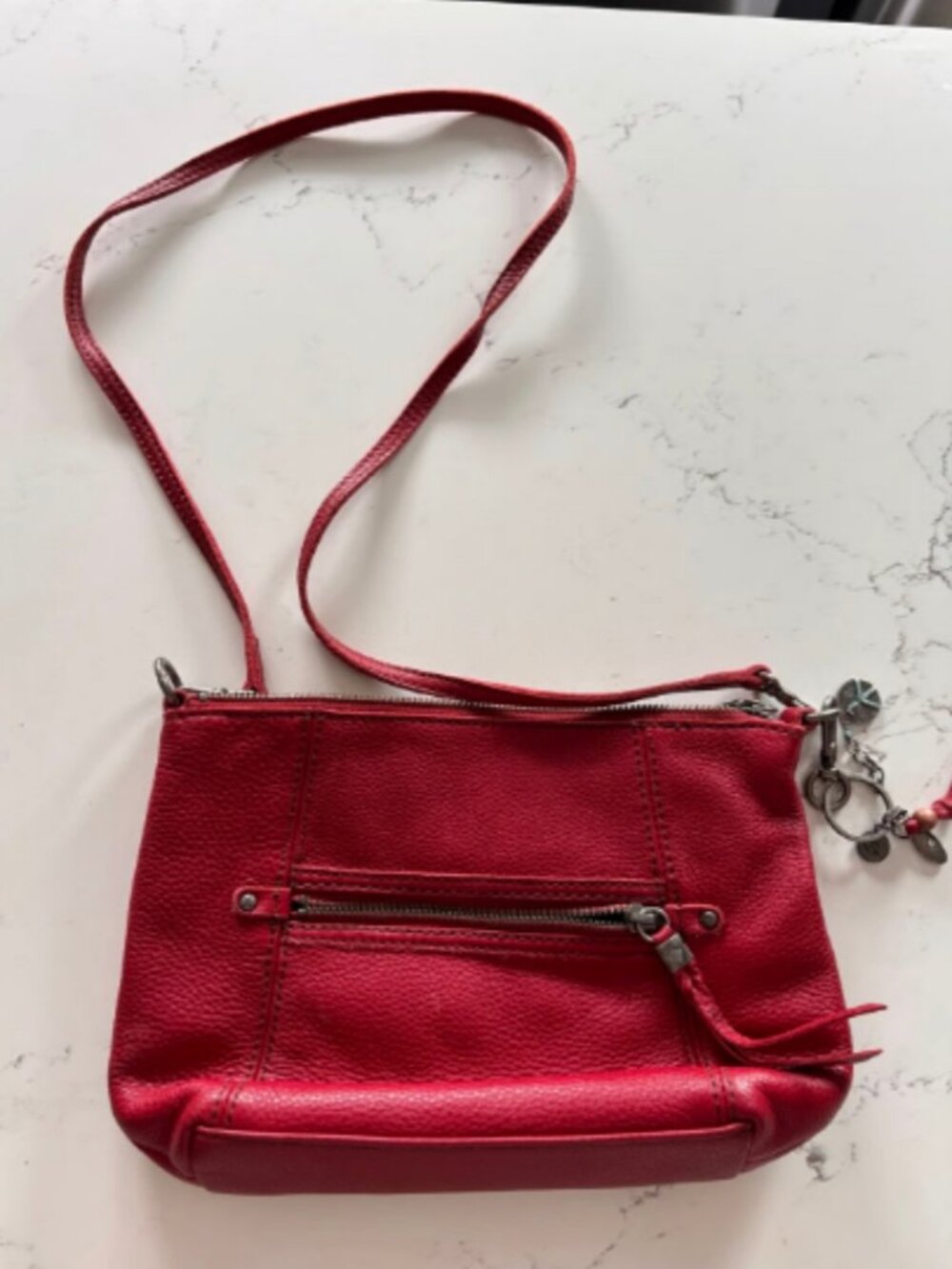 The Sak Red Pebbled Leather Crossbody Bag with Bag Charm & Front Zip Pocket